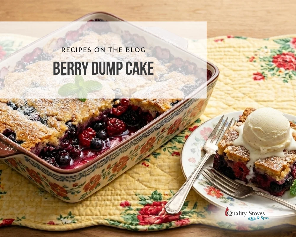 Berry dump cake with mixed berries in a floral baking dish served with a scoop of vanilla ice cream.