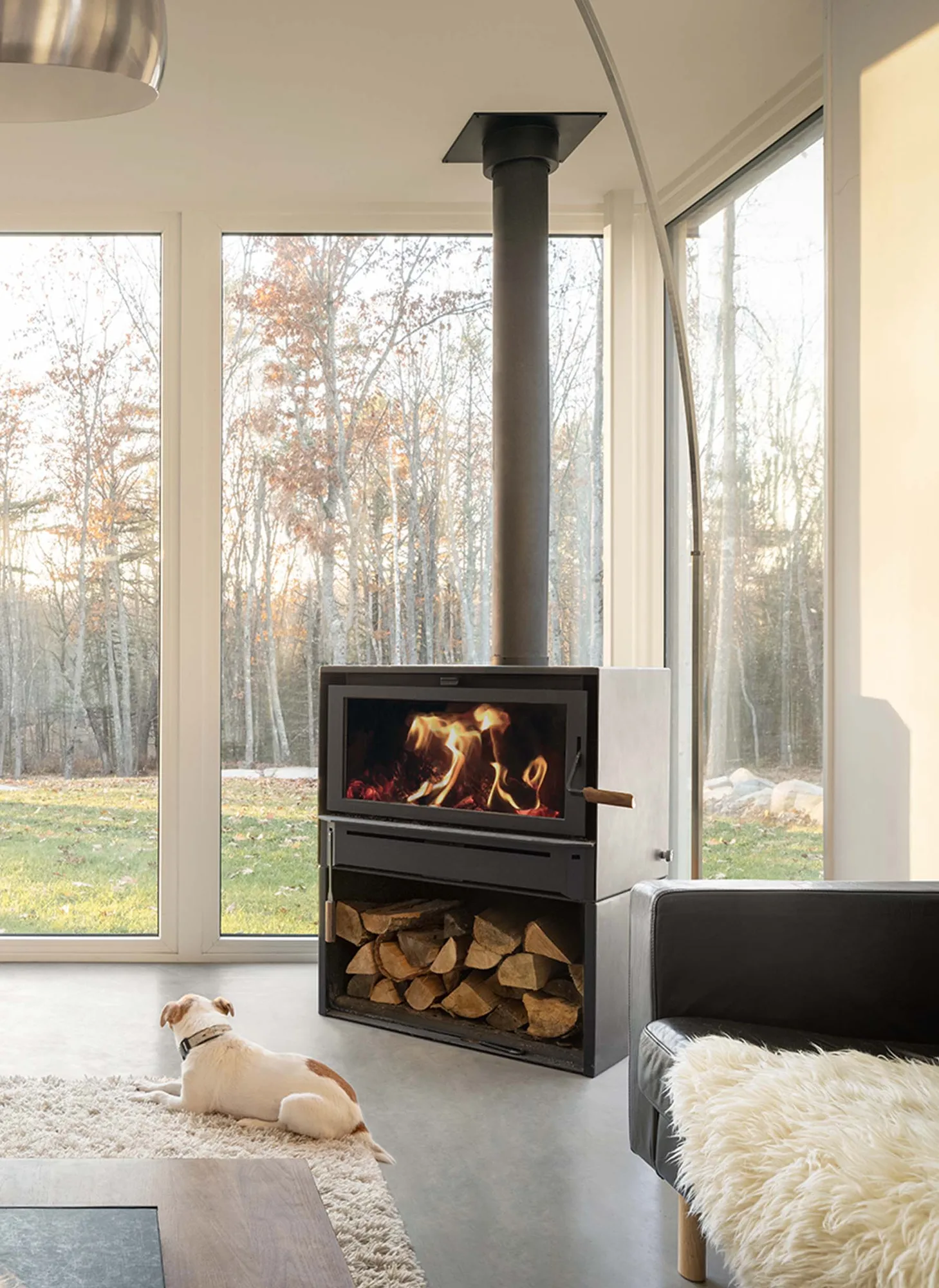 Blaze King Boxer 24 wood stove in a modern living room with floor-to-ceiling windows