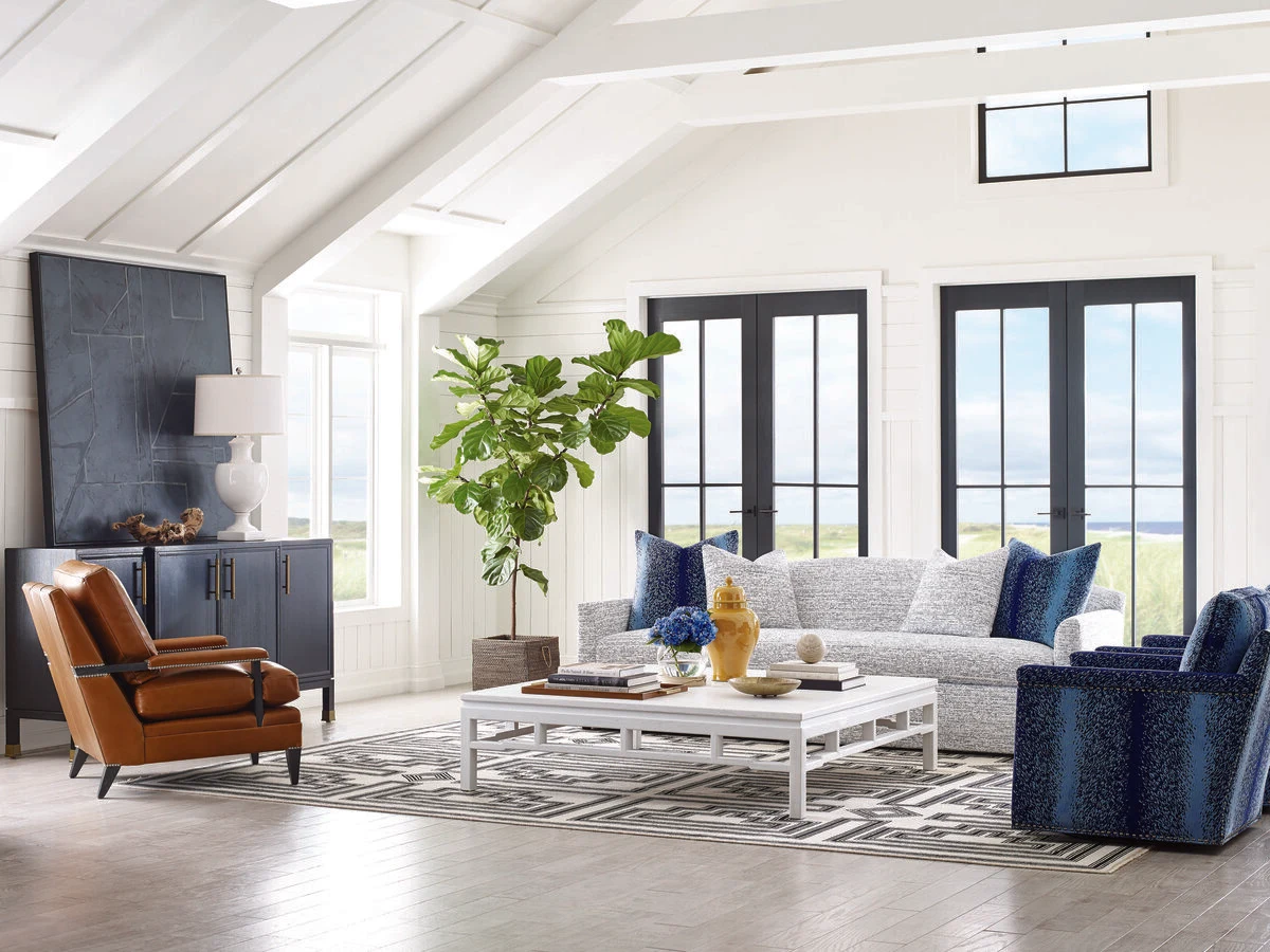 Bright living room with a grey sofa and navy accent chairs