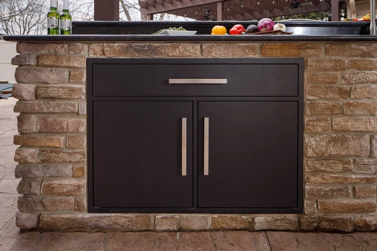 Custom outdoor kitchen cabinet detail showing premium dark finish and brushed hardware. Available near Coeur d'Alene, ID.