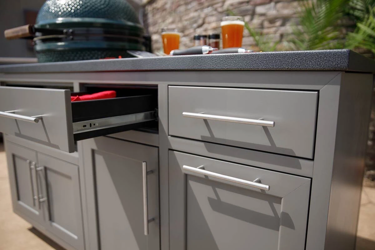 Custom outdoor kitchen with stainless steel grill and premium cabinetry in a warm outdoor entertaining space. Available near Coeur d'Alene and Spokane.