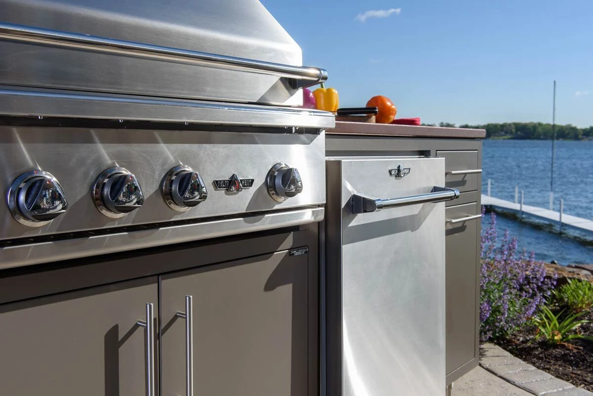 Custom outdoor kitchen grill detail showing premium stainless steel finish and multiple burners. Available in North Idaho and Washington.