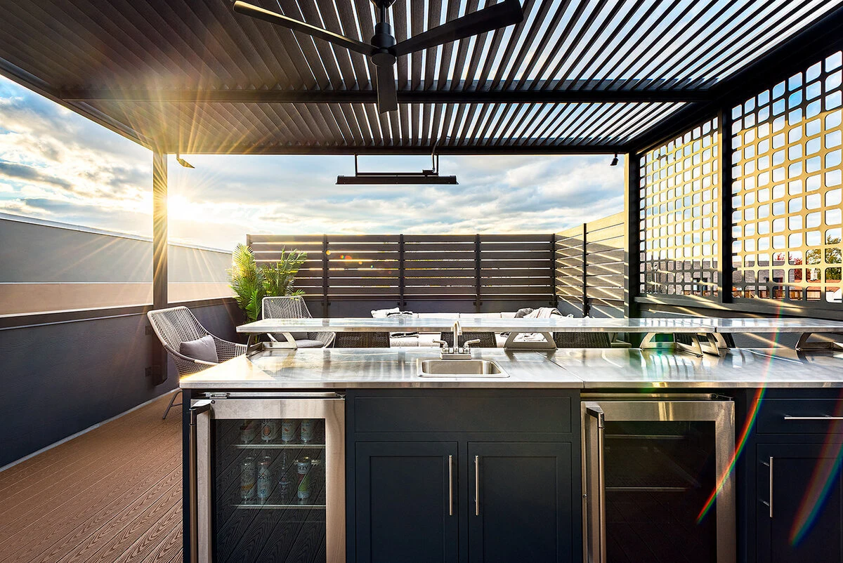 Custom outdoor kitchen with stainless steel grill and cabinetry on a covered outdoor patio. Shop near Spokane, WA.