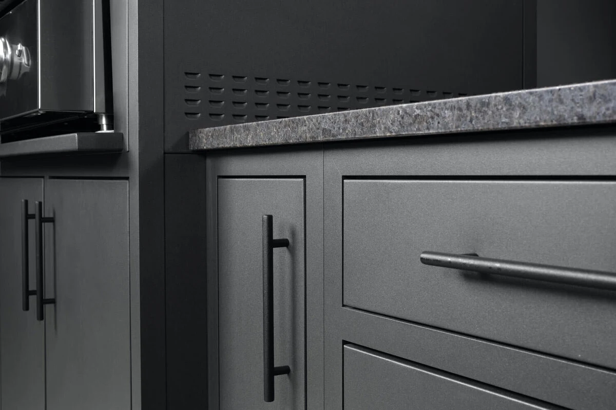 Custom outdoor kitchen with dark cabinetry and stainless steel appliances in a sleek modern setting. Available near Spokane, WA.