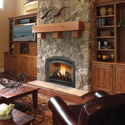 Fireplace Xtrordinair 864 TV 40K gas fireplace with an arched face set in a stone wall beneath a wood mantel.