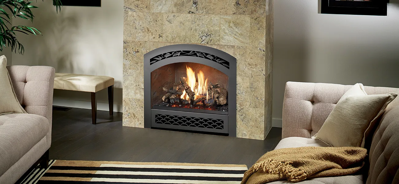 Fireplace Xtrordinair 864 TV 40K Deluxe gas fireplace with an arched designer face set in a floor-to-ceiling stone wall.