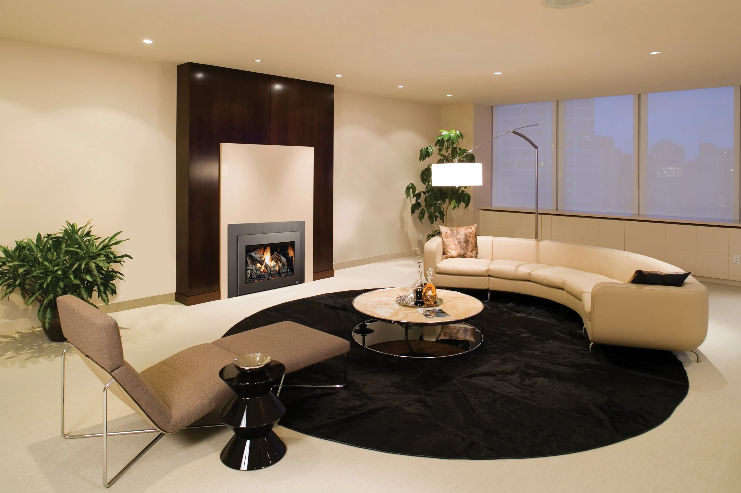 Fireplace Xtrordinair 34 DVL Deluxe Ember-Glo gas insert in a modern fireplace surround in a contemporary living room.