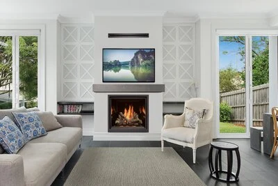 Fireplace Xtrordinair ProBuilder 36 Clean Face Deluxe gas fireplace installed in a white living room wall beneath a mounted TV.
