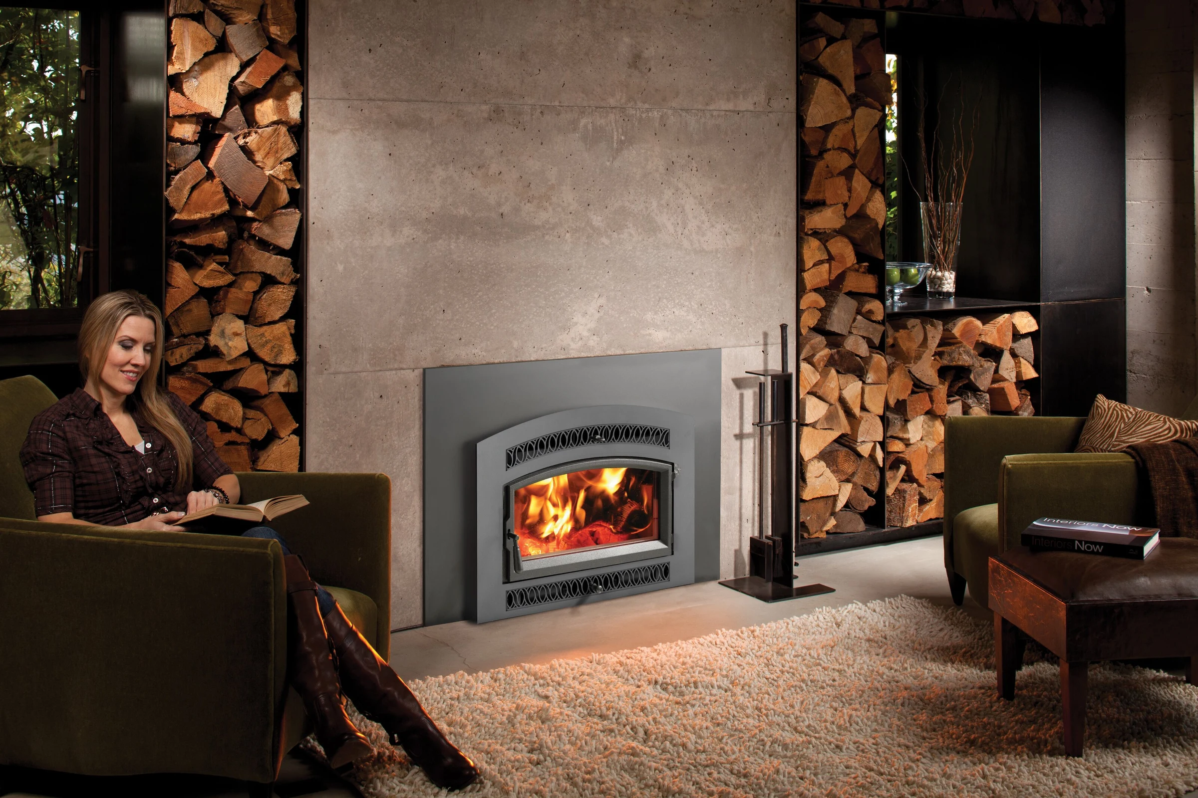 Fireplace Xtrordinair Medium Flush NexGen-Hybrid wood insert with rectangular face in a stone surround with stacked firewood.