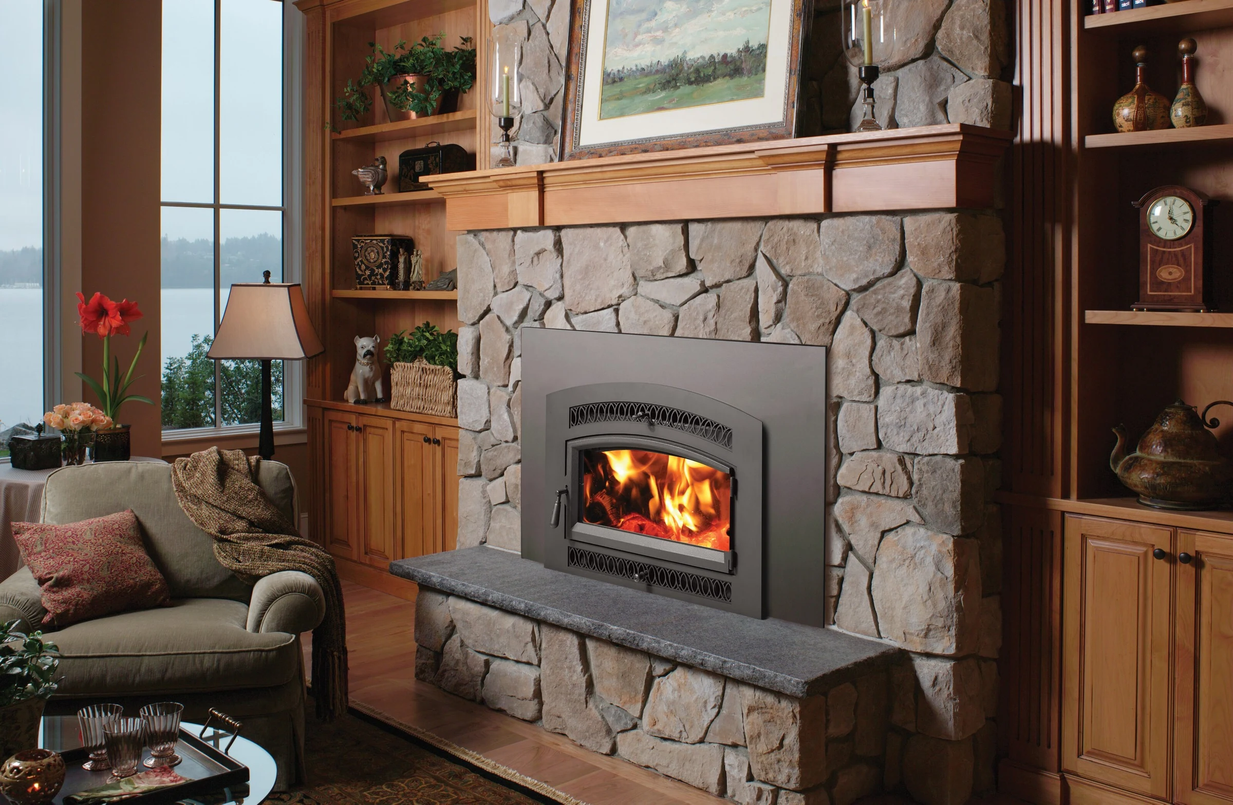 Fireplace Xtrordinair Medium Flush NexGen-Hybrid wood insert with arched face installed in a light stone fireplace surround.