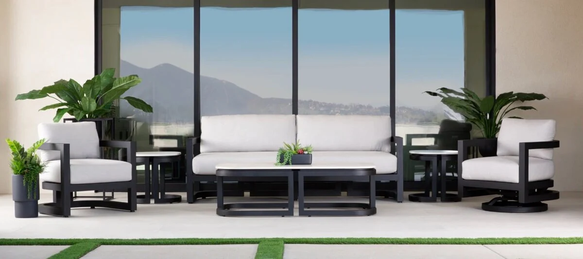 Black-framed outdoor sofa and lounge chairs on a modern patio