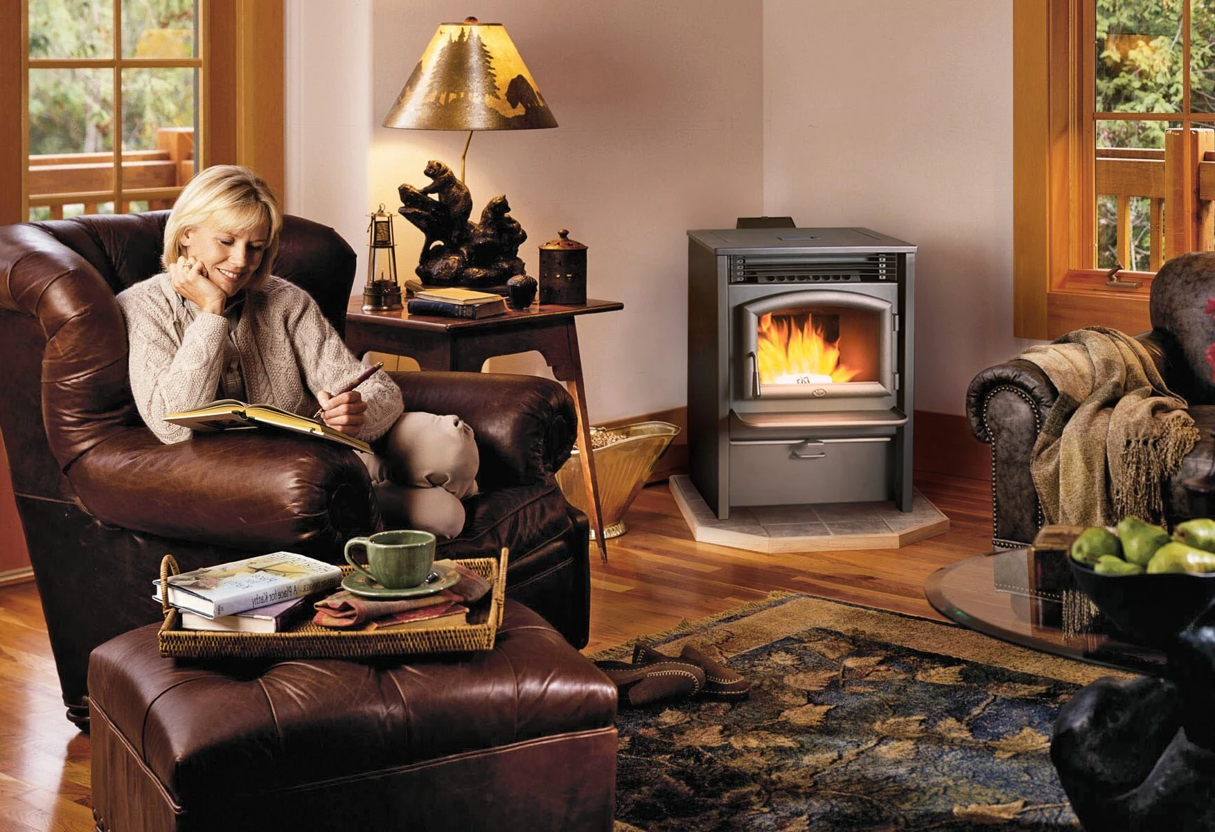 Lopi AGP Pellet Stove in a cozy living room with warm lighting and a person seated in a leather chair.