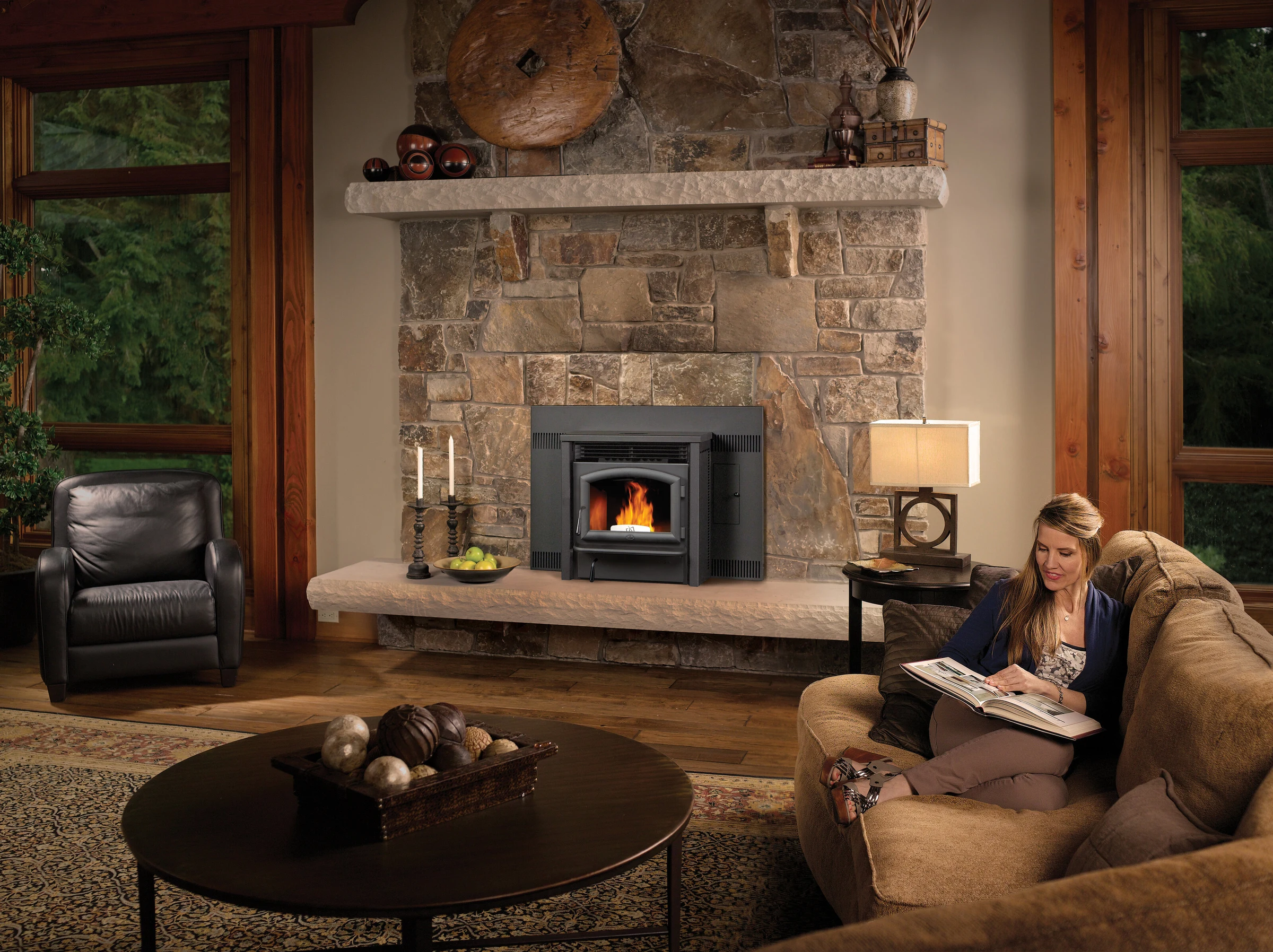 Lopi AGP pellet insert in a stone fireplace surround in a cozy sitting room.