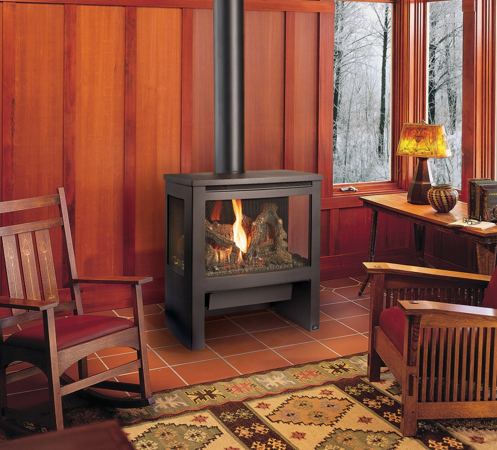 Lopi Cypress Bay Window Gas Stove in a warm living space with orange curtains, a patterned area rug, and an armchair nearby.