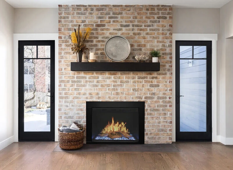 Modern Flames electric fireplace set into a brick surround with a dark wood mantel.