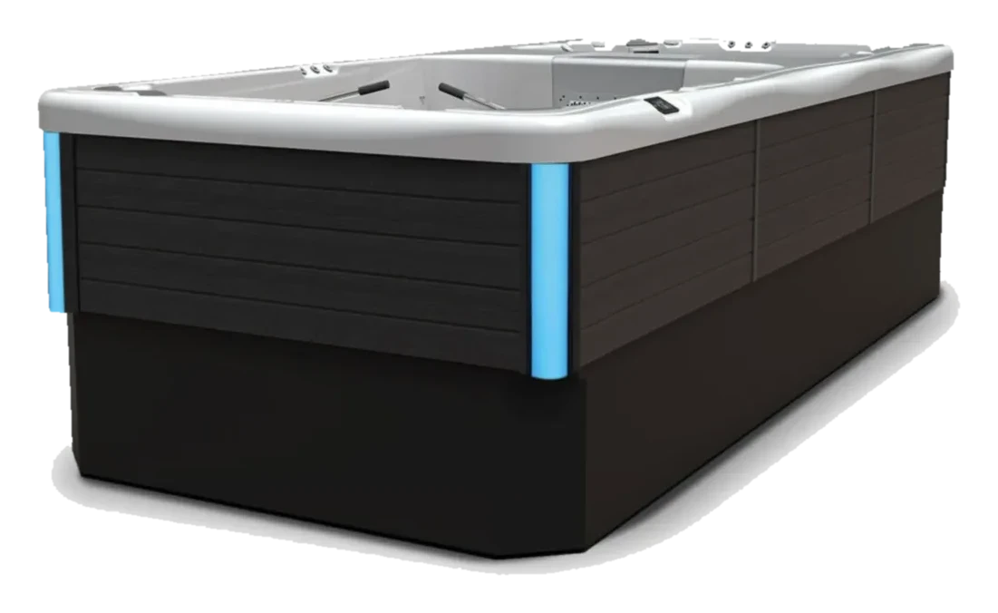 Angled perspective view of the Wellis Elba Deluxe swim spa showing the dark cabinet exterior with blue LED accent lighting along the side panel.