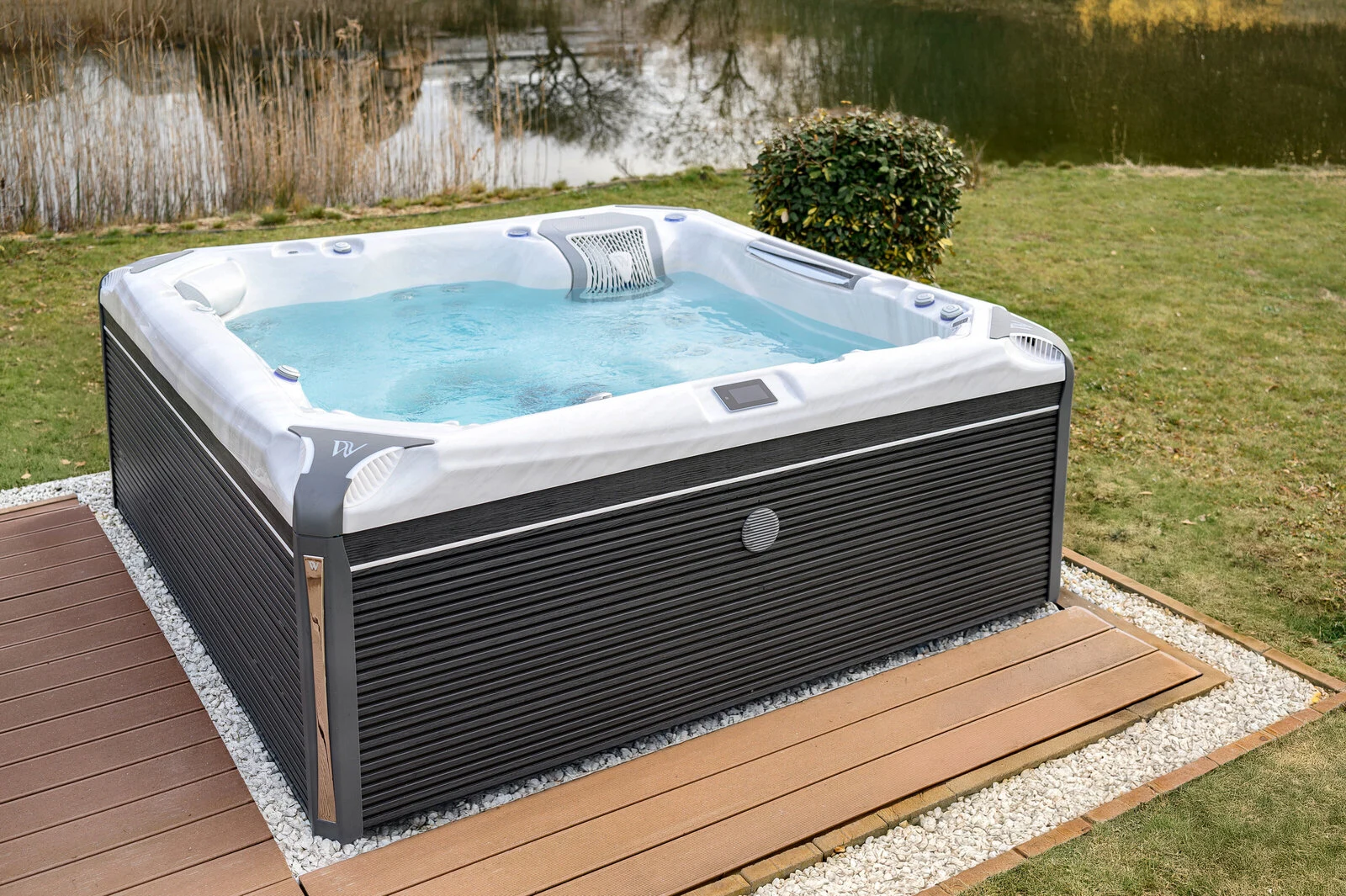 Wellis Kilimanjaro Life premium hot tub with bubbling water installed on a backyard deck