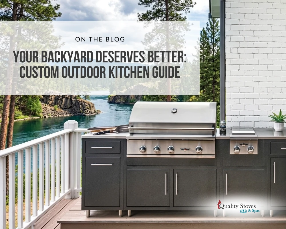 Custom outdoor kitchen with stainless steel grill and dark aluminum cabinets on a deck overlooking a river.
